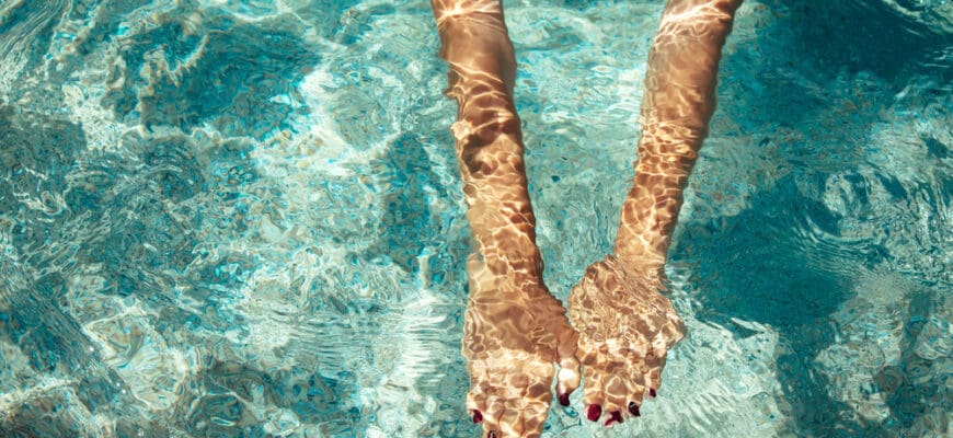 Young,Woman,Swimming,On,The,Sea.,Female,Hands,Under,Clear