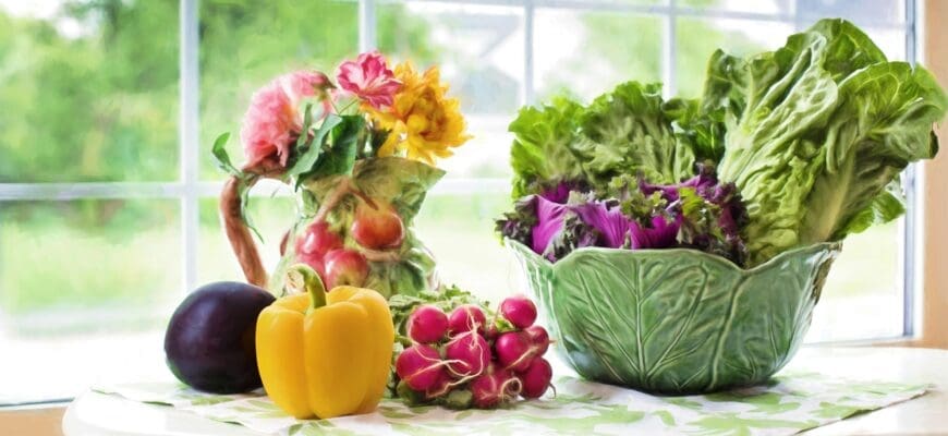 Window Sill with a Yellow Pepper, Radishes, Ceramic Lettuce-Shaped Bowel with Lettuce in it, and a Vase with Flowers in it.